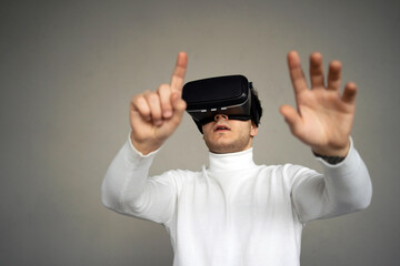 Naklejka premium the man put on black 3D virtual reality glasses. learning is in a new digital game. at home, one stands in the living room. a modern gadget for entertainment