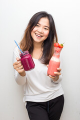 Beautiful healthy glasses women drinking strawberry and blueberry smotthie yogurt