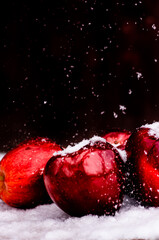 Red apples on the snow background.