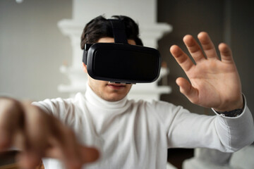 virtual reality. a man learns to be in a new digital game. put on a modern gadget glasses for fun. the new reality of modern technology. VR 3d glasses in black color.