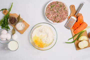 the process of cooking Uzbek manti at home, the ingredients are meat, vegetables, dough. top view on a light background © Taranova_ksenya