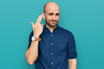 Young hispanic man wearing casual clothes shooting and killing oneself pointing hand and fingers to head like gun, suicide gesture.