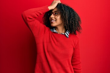 Beautiful african american woman with afro hair wearing sweater and glasses smiling confident...