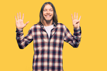 Handsome caucasian man with long hair wearing hipster shirt showing and pointing up with fingers number nine while smiling confident and happy.