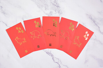 Chinese New Year 2021 red ang pao on white marble background. Translation Chinese - Wishing you luck in this year of the ox and wishing for a better year than last year