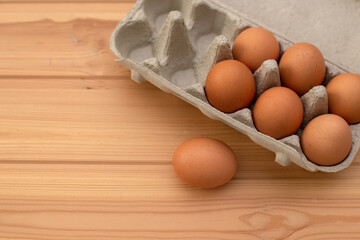 eggs in a package on a wooden table, ingredients