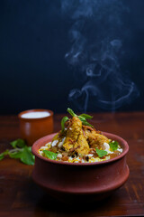 Delicious spicy chicken biryani , Indian or Pakistani ramzan food. on smoky background.