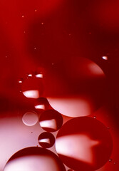 Abstract background with colorful oil drops in water. Abstract psychedelic pattern image. Red, purple and scarlet colored abstract pattern.