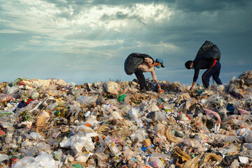 Poor people collect garbage for sale People living in garbage heaps walking to collect recyclable waste to be sold to poverty concept world environment day