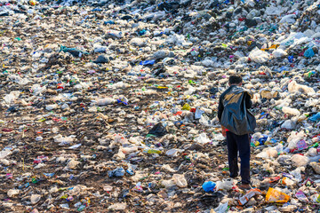 Poor people collect garbage for sale People living in garbage heaps walking to collect recyclable...