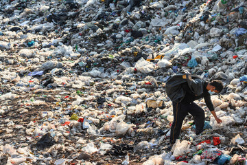 Poor people collect garbage for sale People living in garbage heaps walking to collect recyclable...
