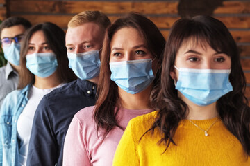 Crowd of young people wearing masks on their faces during the coronavirus pandemic - New normal...