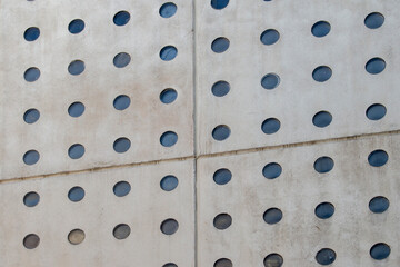 concrete wall with opaque glass circles, divided into four parts