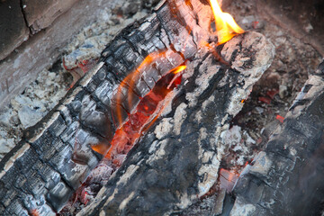 Glowing embers in hot red color, abstract background. The hot embers of burning wood log fire....