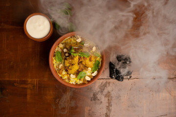 Delicious spicy chicken biryani , Indian or Pakistani ramzan food. on smoky background.
