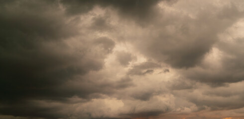 Dark storm cloud Rain clouds in sunset or sunrise sky Dramatic black cloudscape in bad weather day