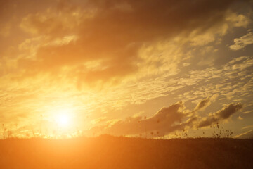 Silhouette of woman praying over beautiful sky background