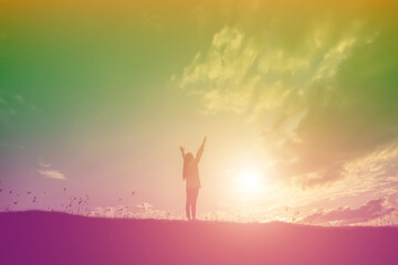 Silhouette of woman praying over beautiful sky background