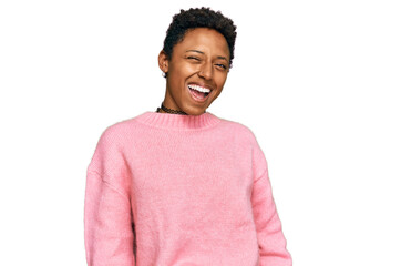 Young african american woman wearing casual clothes winking looking at the camera with sexy...