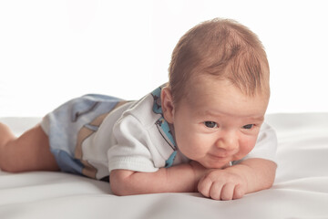 Smiling caucasian 1 month old child posing on the white isolated background.