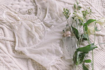 Happy Women's day. Stylish lingerie, perfume, jewelry and spring flowers on sweater. Soft image