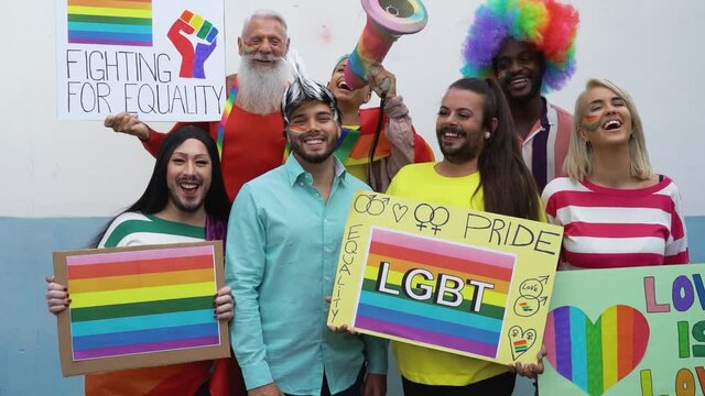 Happy Multiracial people celebrating gay pride event - Group of friends with different age and race fighting for gender equality - Lgbt protest concept