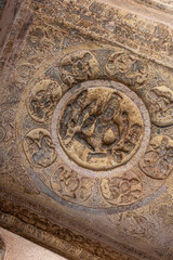 Badami, Karnataka, India - November 7, 2013: Cave temples above Agasthya Lake. Closeup of Vishnu sculpture on ceiling of cave 3.