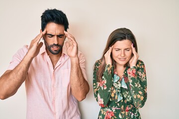 Beautiful young couple of boyfriend and girlfriend together with hand on head for pain in head because stress. suffering migraine.