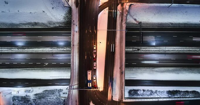 Aerial time-lapse of the bridge over the highway in winter.