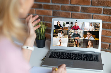 Back view over woman shoulder on the laptop screen with a diverse multi ethnic group of people on...