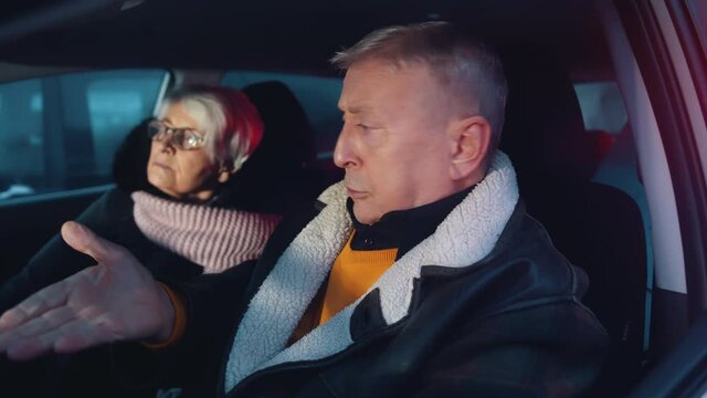 Elderly couple looking at each other in shock realising there is police behind their car. Speeding ticket. High quality 4k footage