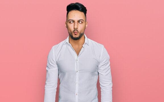 Young arab man wearing casual clothes making fish face with lips, crazy and comical gesture. funny expression.