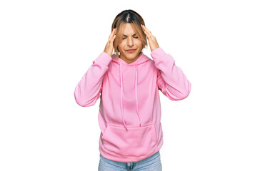 Obraz na płótnie Canvas Young caucasian woman wearing casual sweatshirt with hand on head for pain in head because stress. suffering migraine.