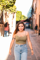 Portrait of young woman with nice hair in the city, mexico, fake henna tattoo in her arm
