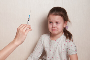 a frightened child is afraid of an injection