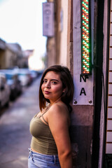 Beautiful healthy young woman smiling with his finger pointing and looking at on light, and camera