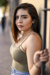 Beautiful healthy young woman smiling with his finger pointing and looking at on light, and camera