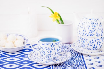 Porcelain set of cup and teapot, blue tea, flower