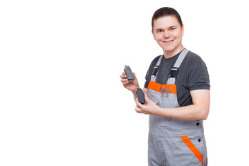 male employee in gray uniform of car mechanic worker with spanner wrench in his pocket holds brake...