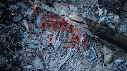 Coals that smolder in the grill. A dying fire. Living fire.