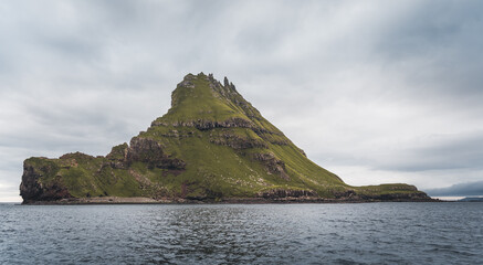 Fototapeta na wymiar Top view vertical composition with the iconic Drangarnir gate, Tindholmur and mykines island in the background, Faroe Islands