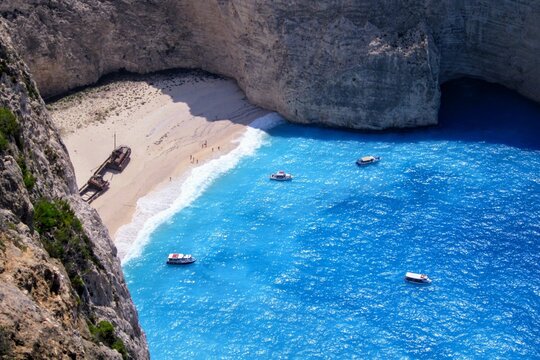 Navagio bay, Navagio beach and ship wreck. The most famous natural landmark of Zakynthos, Greece, Europe. Amazing aerial view from the view from a wild slope and rocks.