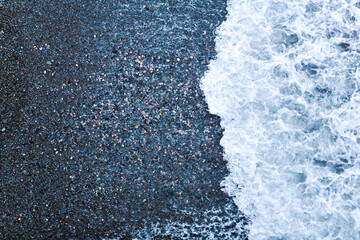 surf on a pebble beach, top view
