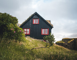 Obraz premium Kirkjuboargardur, also called Roykstovan, is a historic farm and museum in Kirkjubour, Faroe Islands. Built in the 11th century it is one of the oldest still inhabited wooden houses of the world.