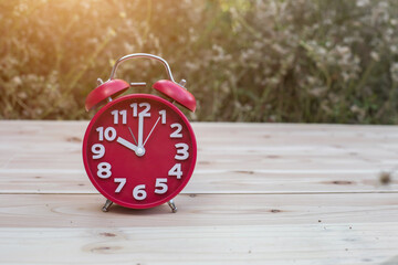 alarm clock with abstract nature bokeh blur background.