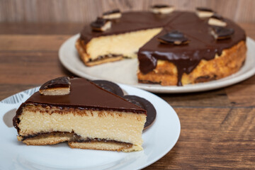 Cake with Chocolate Glaze and orange biscuit on wooden background