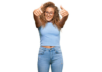 Beautiful caucasian teenager girl wearing casual clothes and glasses approving doing positive...