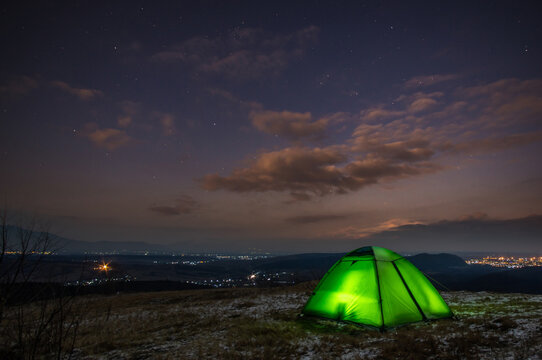Tent on the background of a winter sunset in the mountains