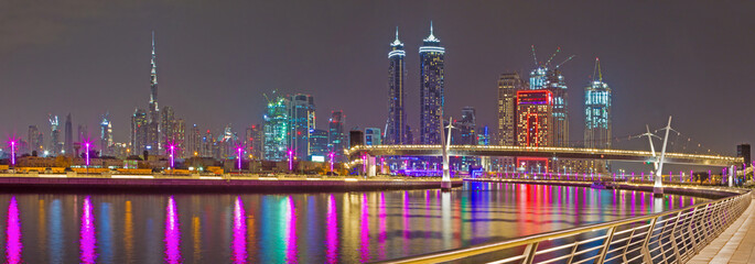 Dubai - The evening skyline with the bridge over the new Canal and Downtown.