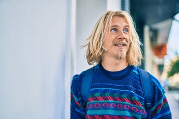 Young scandinavian student man smiling happy standing at the city.